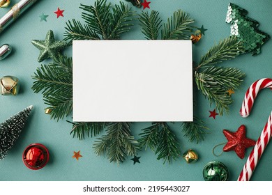 Christmas card mock up. Modern greeting card flat lay with stylish christmas decorations and fir branches on green background. Empty postcard template with space for text. Merry Christmas! - Powered by Shutterstock