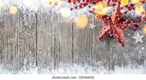 Christmas Card With Stars Decorations And Berries On Snowy Wood
