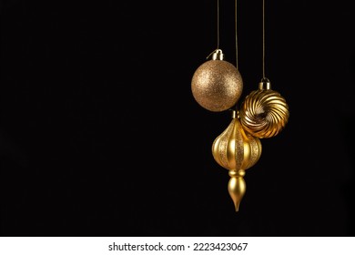 Christmas card with three golden balls decorations on black background with copy space - Powered by Shutterstock