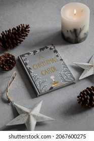 Christmas Carol Book Surrounded By Christmas Items