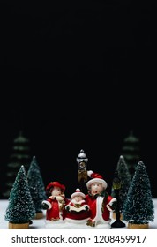  Christmas Caroling Or Carolers Singing Outside With Snows.Family Group Singing Carol Song On Celebration Of Christmas Day In Winter Time.