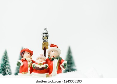 Christmas Caroling Or Carolers Singing Outside With Snows.Family Group Singing Carol Song On Celebration Of Christmas Day In Winter Time.