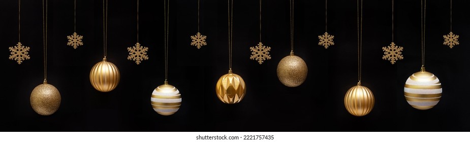 Christmas celebration holiday banner template greeting card panorama - Group of hanging gold golden Christmas balls Christmas baubles and ice crystals, isolated on black background.