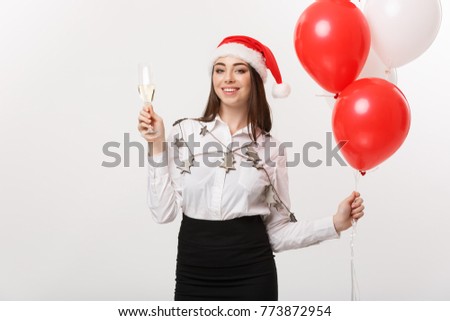 Christmas Celebration - Young beautiful business woman celebrating christmas with glass of champagne and confetti background.