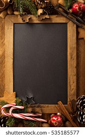 Christmas Chalkboard Background With Nuts, Candy Cones, Spices And Pine Tree