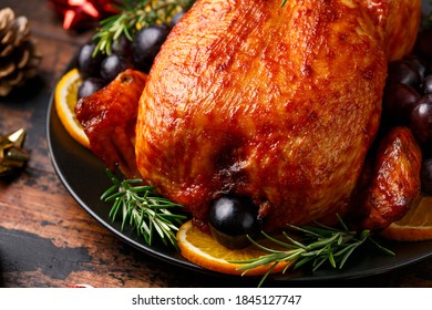 Christmas Chicken, roast in oven with decoration, gifts, green tree branch on wooden rustic table - Shutterstock ID 1845127747