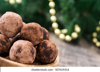 Christmas Chocolate Truffles And Christmas Decoration On Wooden Table

