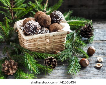 Christmas Chocolate Truffles In A Wicker Box The Fir Tree Branches On Wooden Table.