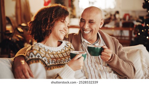 Christmas, coffee and couple in home on sofa for holiday, vacation and festive season. Love, marriage and man and woman with hot chocolate drink for celebration, party and tradition in living room - Powered by Shutterstock