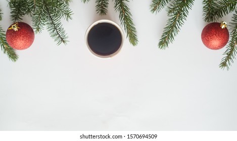 Christmas Coffee.Top View, A Cup Of Coffee And Two Red Balls With Christmas Tree Branches On White Background,copyspace In The Down.