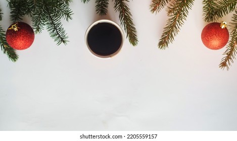 Christmas Coffee.Top View, A Cup Of Coffee And Two Red Balls With Christmas Tree Branches On White Background,copyspace In The Down