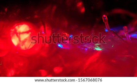 Christmas colorful New Year's Bokeh neon lights. Abstract Blurred photo background with blinking lights from tangled garlands. Decoration with bright colored neon red yellow pink flickering lights