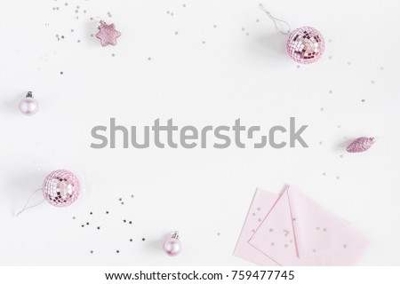 Christmas composition. Christmas balls, envelopes, pink and silver decorations on white background. Flat lay, top view, copy space