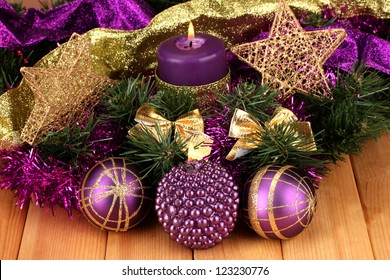 Christmas Composition  With Candles And Decorations In Purple And Gold Colors On Wooden Background