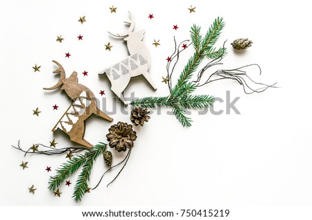 Christmas composition with deer, stars and fir branches. New Year background for presentation of work or text. Beautiful greeting card. Copy space.Top view