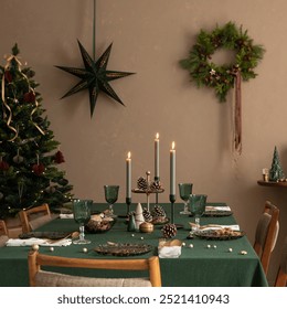 Christmas composition of dinning room interior with table with green table cloth, wooden console, christmas tree, wreath, cookies, candle with candlestick and personal accessories. Home decor Template - Powered by Shutterstock