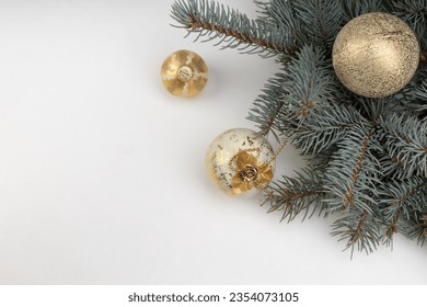 Christmas composition with fir branches, christmas balls and tinsel. Top view with copy space.