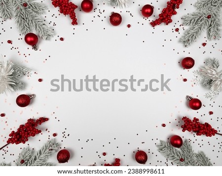Christmas composition, fir tree branches, red berries, baubles and stars confetti on white background. Christmas, New Year, winter concept. Top view, flat lay, copy space.