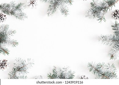 Christmas composition. Frame made of fir tree branches, pine cones on white background. Christmas, winter, new year concept. Flat lay, top view, copy space - Powered by Shutterstock