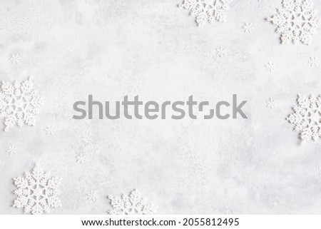 Christmas composition. Frame made of snowflakes on gray background. Christmas, winter, new year concept. Flat lay, top view