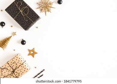 Christmas composition. Gift boxes, black and golden decorations on white background. Christmas, winter, new year concept. Flat lay, top view, copy space