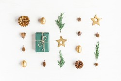 Christmas Composition. Gift, Christmas Golden Decorations, Cypress Branches, Pine Cones On White Background. Flat Lay, Top View