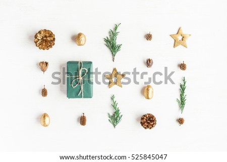 Christmas composition. Gift, christmas golden decorations, cypress branches, pine cones on white background. Flat lay, top view
