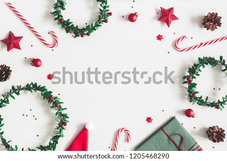 Christmas composition. Gift, wreaths, red decorations on pastel gray background. Christmas, winter, new year concept. Flat lay, top view, copy space