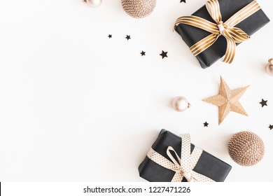 Christmas composition. Gifts, black and golden decorations on white background. Christmas, winter, new year concept. Flat lay, top view, copy space