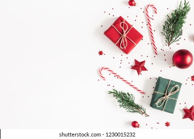 Christmas composition. Gifts, fir tree branches, red decorations on white background. Christmas, winter, new year concept. Flat lay, top view, copy space - Shutterstock ID 1230015232