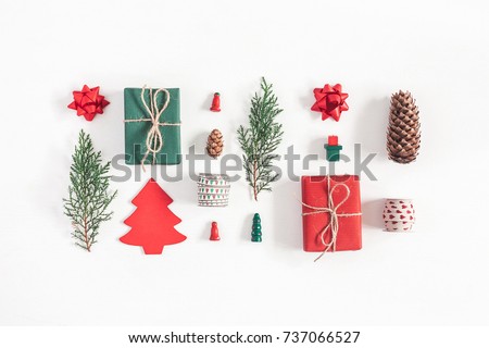 Christmas composition. Christmas gifts, pine branches, toys on white background. Flat lay, top view.