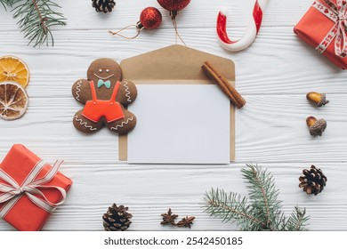 Christmas composition. Gifts, pine cones, letter for to do list, fir branches, candy, gingerbread man, spices and other decorations on wooden white background. Flat lay, top view. - Powered by Shutterstock