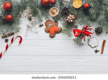 Christmas composition. Gifts, pine cones, fir branches, candy, gingerbread man, spices and other decorations on wooden white background. Flat lay, top view. - Powered by Shutterstock