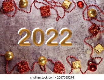 Christmas Composition. Gifts, Red And Gold Jewelry On A Gray Background. Christmas, Winter, New Year Concepts. Flatlay, Top View, Text 2022