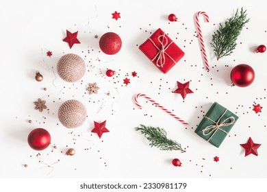 Christmas composition. Christmas gifts, red and golden decorations on white background. Flat lay, top view