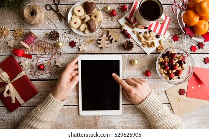 Christmas Composition. Man Holding Tablet. Studio Shot.