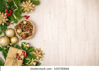 Christmas composition on wood background for your winter holidays greetings. Christmas gift, traditional basket, anise stars, pine cones, cinnamon sticks, golden nuts and bells, mistletoe and Christma - Powered by Shutterstock