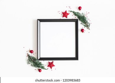 Christmas Composition. Photo Frame, Red Decorations, Fir Tree Branches On White Background. Christmas, Winter, New Year Concept. Flat Lay, Top View, Copy Space