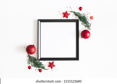 Christmas Composition. Photo Frame, Red Decorations, Fir Tree Branches On White Background. Christmas, Winter, New Year Concept. Flat Lay, Top View, Copy Space