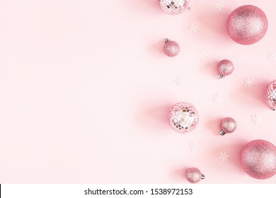 Christmas composition. Pink decorations on pastel pink background. Christmas, winter, new year concept. Flat lay, top view, copy space