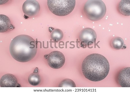 Christmas composition christmas silver tree toys ,silver snowflakes and christmasdecoration at the pink background,copy space,top view photo.