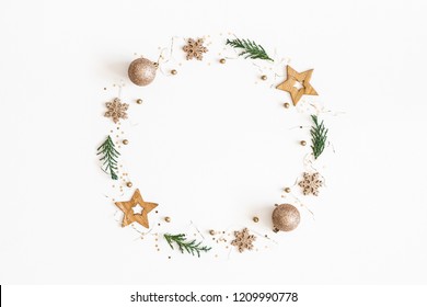 Christmas composition. Christmas wreath made of golden decorations, fir tree branches on white background. Flat lay, top view, copy space