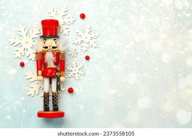 Christmas concept background. Top view of Christmas wooden nutcracker toy solider with space for text over a blue background