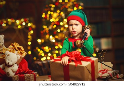 Christmas Concept. Little Elf  Child  Working, Talking On The Phone