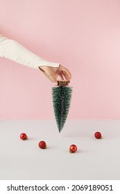 Christmas concept with christmas tree upside down against pastel pink and grey background.Retro minimal style.