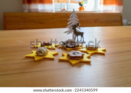 Christmas Coockies Decoration  with Stars, a Elck, A Tree, on an Diningtable
