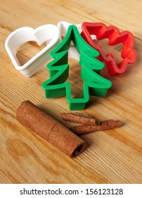 Christmas Cookie Cutters On The Pastry Board With Cinnamon