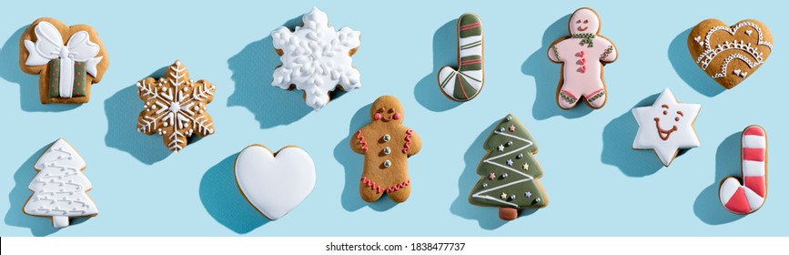 Christmas cookie pattern. Blue seamless background. Winter holidays dessert ornament. Gingerbread biscuit collection creative arrangement isolated on light.