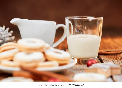 Christmas cookies and glass of milk on a brown wooden table with white sugar - Shutterstock ID 527944726