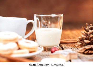 Christmas cookies and glass of milk on a brown wooden table with white sugar - Shutterstock ID 529832638